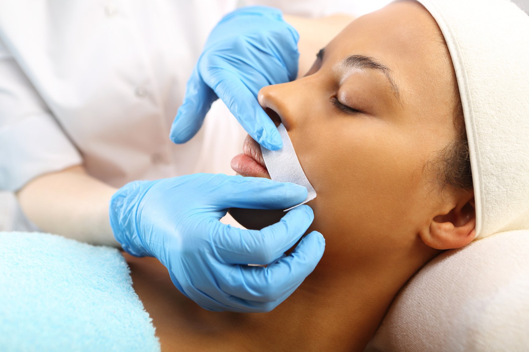 Woman in a beauty salon waxing during surgery