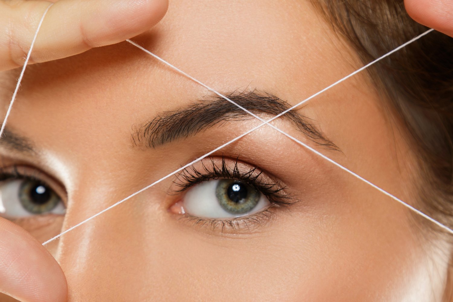 Eyebrow threading - epilation procedure for brow shape correction