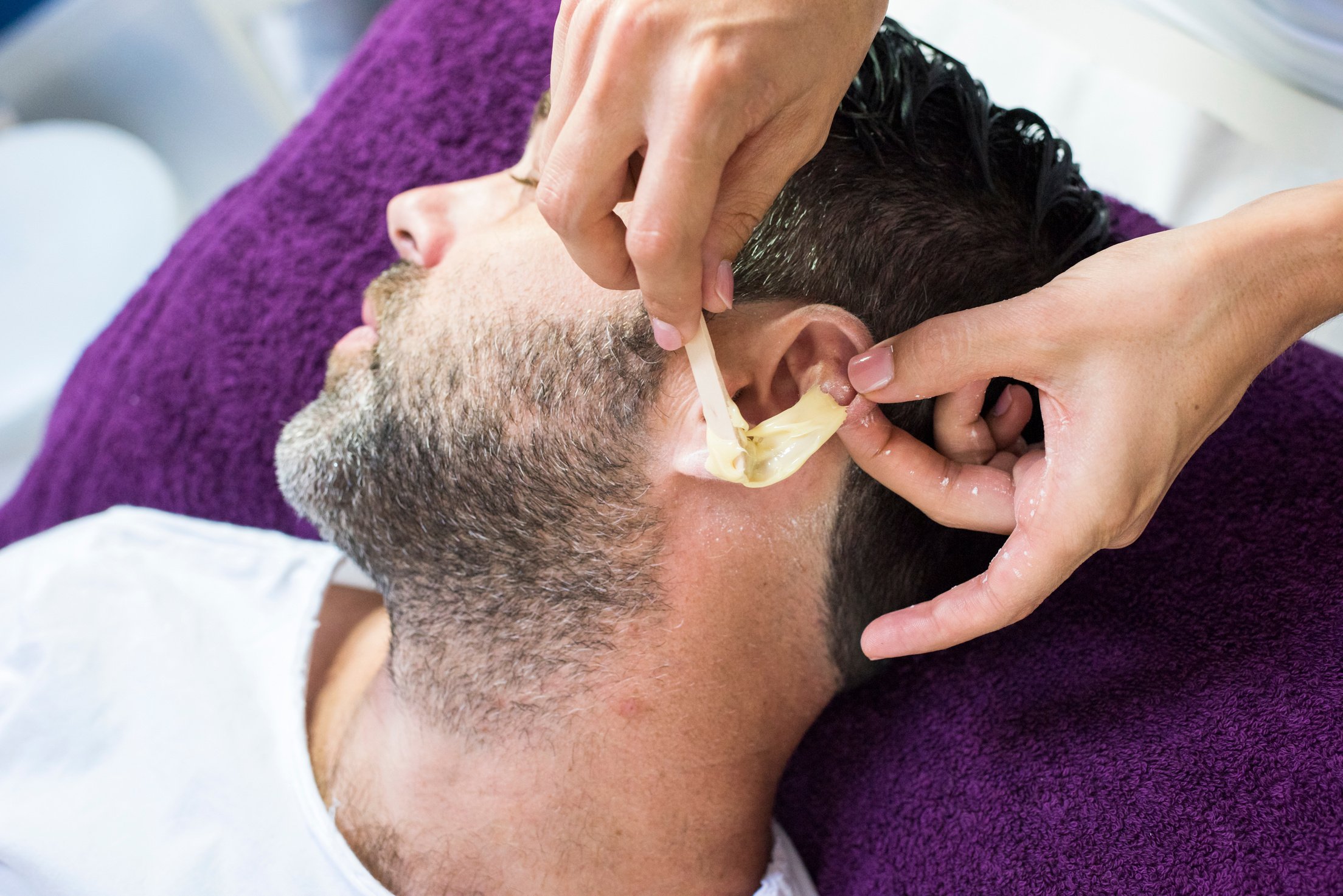 Man getting ears waxed